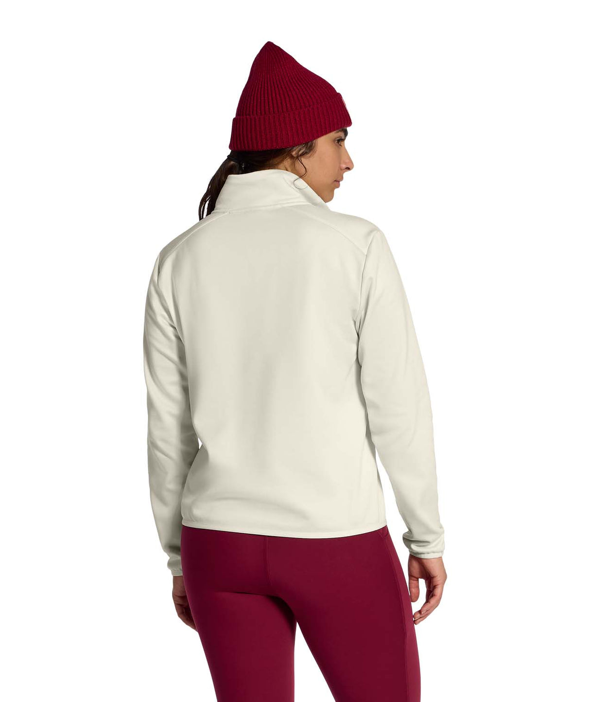 WTNFPerformanceFleece1_4Zip- Person wearing a beige and brown color-blocked jacket with a red beanie on a white background