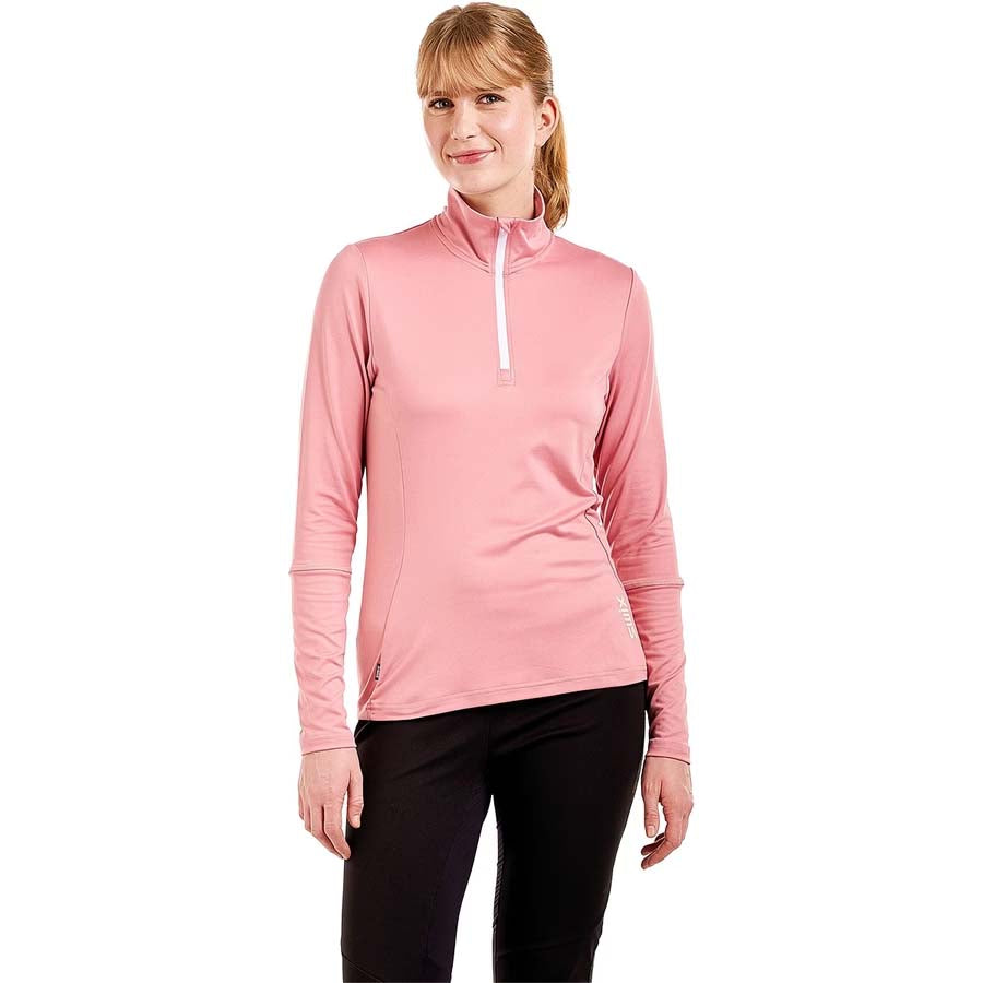 WTista1_2ZipMidlayer- A woman modeling a pink long-sleeve half-zip athletic top with a white zipper pull, paired with black leggings, against a plain white background.