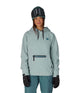 WWaterproofHoody-Person wearing a seafoam hoodie with a brand logo on a white background