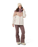 WWinterHavenJacket- Woman wearing a purple, cream, and white jacket on a white background