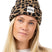 WatcherBeanie- Woman wearing a leopard designed beanie on a white background 