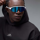 WintertideScratchedHoodie-A black pullover hoodie with a small white Oakley logo on the left chest, displayed against a neutral gray gradient background.