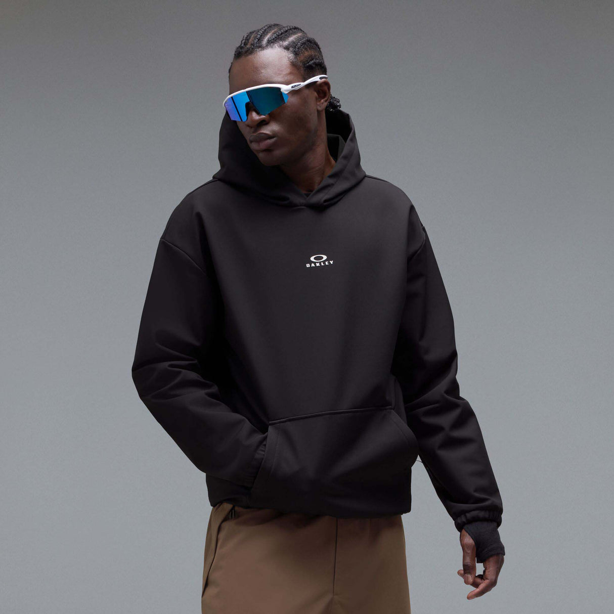WintertideScratchedHoodie-A black pullover hoodie with a small white Oakley logo on the left chest, displayed against a neutral gray gradient background.