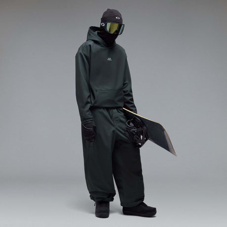 WintertideScratchedHoodie-A dark charcoal gray hooded sweatshirt with a small white Oakley logo on the left chest, displayed against a neutral gray gradient background.