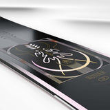Wonder- Black snowboard with a multi colored design in the center shown on a white background