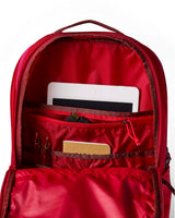 allpa-26l-daypack-A red Cotopaxi backpack with a matte finish, featuring a top zippered compartment, a main compartment, and a front zippered pocket. The brand logo is printed in orange on the front center.