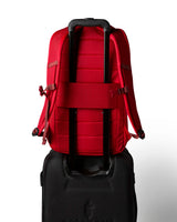 allpa-26l-daypack-A red Cotopaxi backpack with a matte finish, featuring a top zippered compartment, a main compartment, and a front zippered pocket. The brand logo is printed in orange on the front center.
