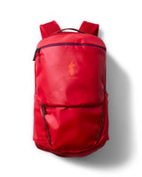 allpa-26l-daypack-A red Cotopaxi backpack with a matte finish, featuring a top zippered compartment, a main compartment, and a front zippered pocket. The brand logo is printed in orange on the front center.