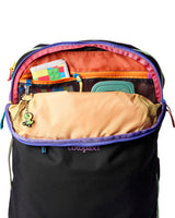 allpa-35l-travel-pack-A black Cotopaxi backpack with a pink llama logo on the front, accented with bright blue, purple, and multicolor zipper details, shown on a white background.