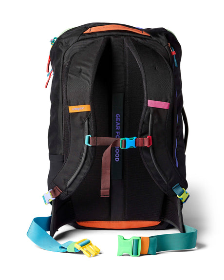 allpa-35l-travel-pack-A black Cotopaxi backpack with a pink llama logo on the front, accented with bright blue, purple, and multicolor zipper details, shown on a white background.