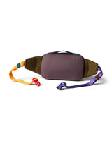 allpa-x-1-5l-hip-pack- A multicolor waist bag with a prominent orange front pocket, dark navy sides, and a patterned strap featuring green, purple, and orange sections, shown on a white background with a soft shadow.