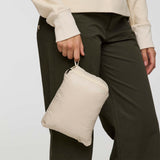 w-fuego-down-jacket- A beige quilted puffer jacket with a gray chest stripe and a visible Cotopaxi logo on the left chest, displayed against a clean white background.